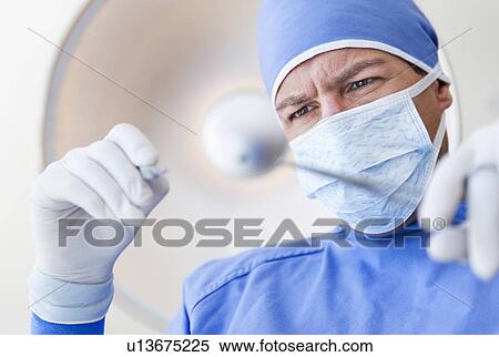 Stock Photography - Male surgeon in operating room. Fotosearch