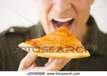 Stock Photograph - Man eating pizza. Fotosearch
