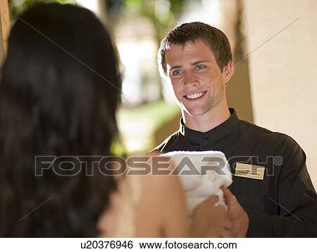Man from room service delivering towels to hotel guest View Large Photo Image Stock Photograph - Man from room service delivering towels to hotel guest. Fotosearch