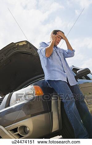 Stock Image - Man having car problems. Fotosearch