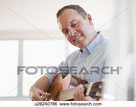 Man playing guitar View Large Photo Image Stock Photograph - Man playing guitar. Fotosearch