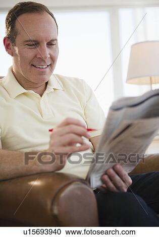 Man reading job adverts in newspaper View Large Photo Image Stock Image - Man reading job adverts in newspaper. Fotosearch