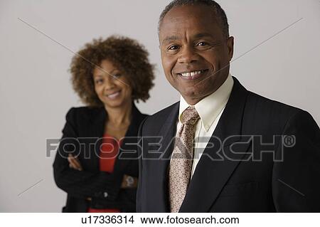 Picture - Mature business people, studio shot. Fotosearch