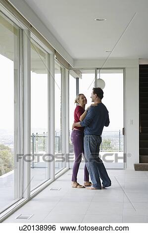 Stock Photograph - Mature couple dancing in empty living room. Fotosearch