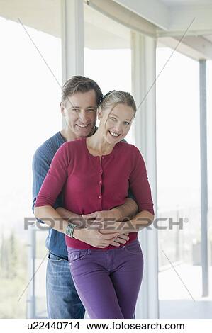 Mature couple in empty living room View Large Photo Image Picture - Mature couple in empty living room. Fotosearch
