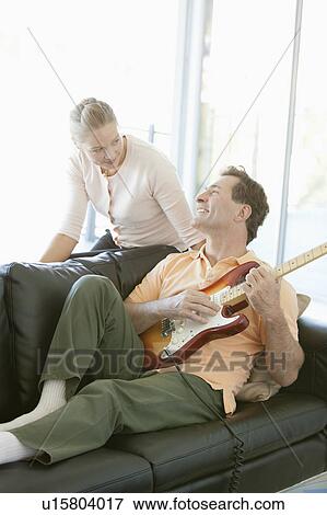 Mature man playing guitar while woman listening View Large Photo Image Stock Photo - Mature man playing guitar while woman listening. Fotosearch