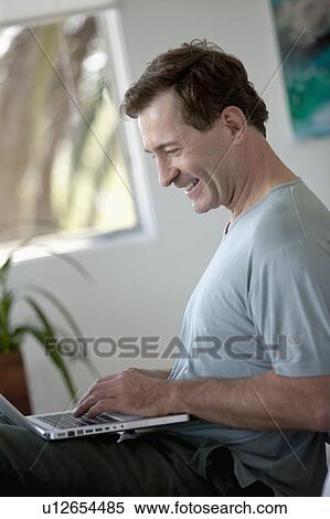 Mature man with laptop View Large Photo Image Stock Photography - Mature man with laptop. Fotosearch