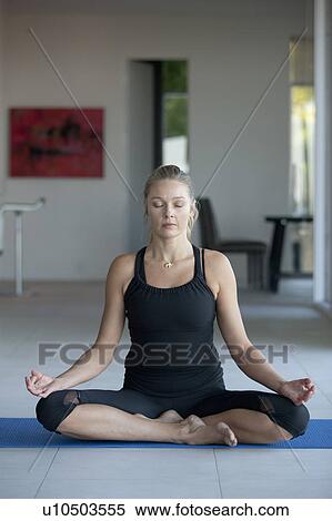 Stock Photography - Mature woman practicing yoga. Fotosearch