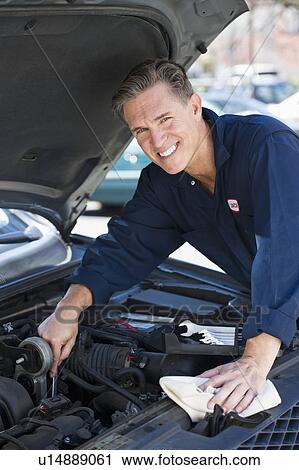 Mechanic repairing car View Large Photo Image Stock Image - Mechanic repairing car. Fotosearch