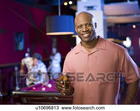 Men enjoying game of pool at bar View Large Photo Image Stock Image - Men enjoying game of pool at bar. Fotosearch