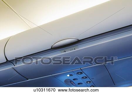 Overhead storage compartment in airplane View Large Photo Image Stock Image - Overhead storage compartment in airplane. Fotosearch
