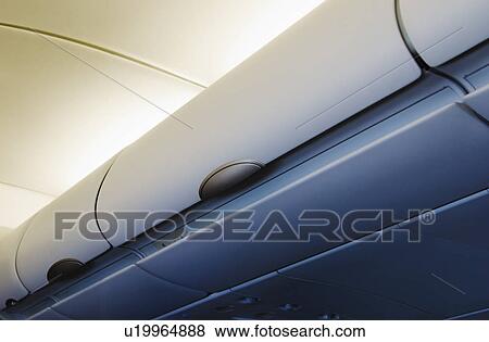 Overhead storage compartment in airplane View Large Photo Image Stock Photo - Overhead storage compartment in airplane. Fotosearch
