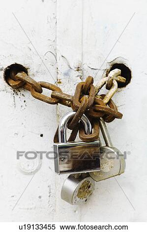 Stock Photography - Padlocks and chains on gate. Fotosearch
