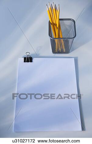 Stock Image - Paper and pencils in cup, studio shot. Fotosearch