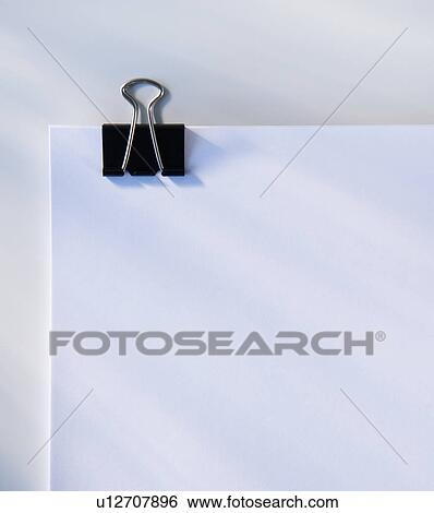 Stock Photograph - Paper with clip, studio shot. Fotosearch