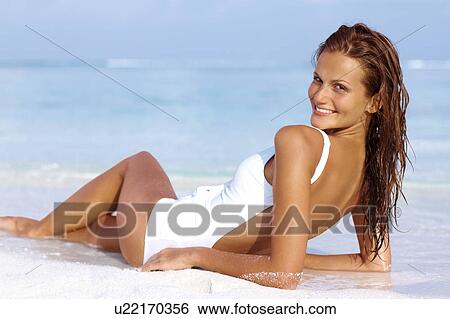 Portrait of attractive young woman relaxing on beach View Large Photo Image Stock Photograph - Portrait of attractive young woman relaxing on beach. Fotosearch