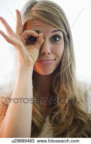 Portrait of blonde woman showing ok sign View Large Photo Image Stock Image - Portrait of blonde woman showing ok sign. Fotosearch