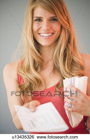 Portrait of blonde woman showing tickets View Large Photo Image Stock Photograph - Portrait of blonde woman showing tickets. Fotosearch