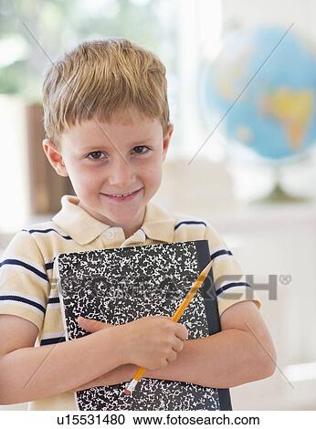 Stock Image - Portrait of boy (4-5) in classroom. Fotosearch