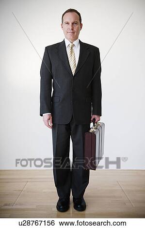Stock Photograph - Portrait of businessman with briefcase. Fotosearch