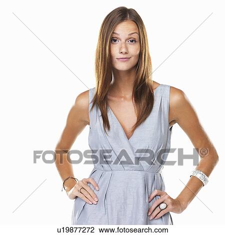 Portrait of confident woman standing with hands on hips against white background View Large Photo Image Stock Image - Portrait of confident woman standing with hands on hips against white background. Fotosearch