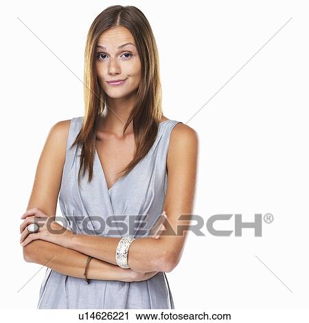 Stock Image - Portrait of cute woman with arms crossed against white background. Fotosearch