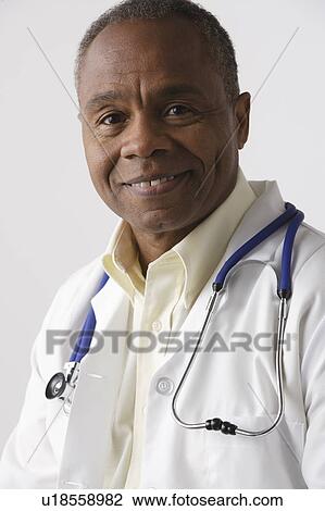 Stock Image - Portrait of doctor, studio shot. Fotosearch