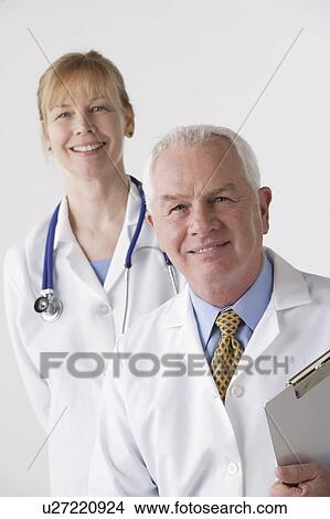 Picture - Portrait of female and male doctor, studio shot. Fotosearch