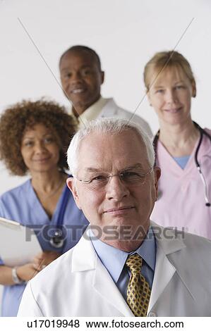 Stock Photo - Portrait of four medical professionals, studio shot. Fotosearch