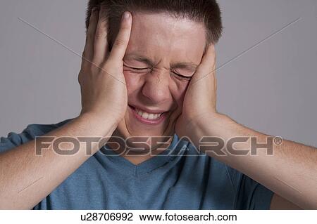 Stock Image - Portrait of frustrated teenager, studio shot. Fotosearch