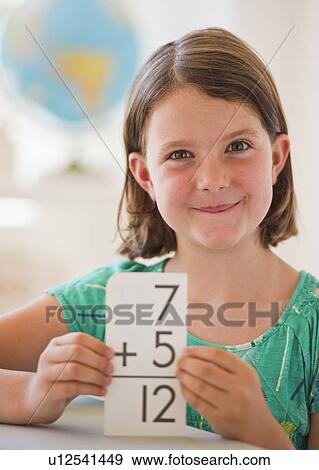 Portrait of girl (6-7) counting in classroom View Large Photo Image Stock Photo - Portrait of girl (6-7) counting in classroom. Fotosearch