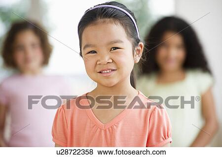 Portrait of girl (6-7) with friends View Large Photo Image Stock Photo - Portrait of girl (6-7) with friends. Fotosearch