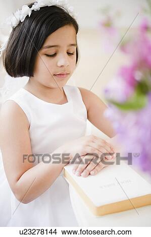 Picture - Portrait of girl (8-9) celebrating Fist Communion. Fotosearch