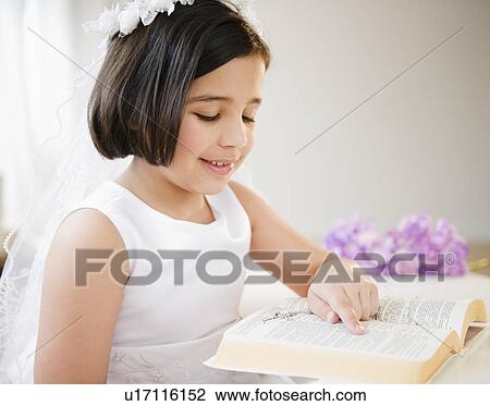 Stock Image - Portrait of girl (8-9) celebrating Fist Communion. Fotosearch