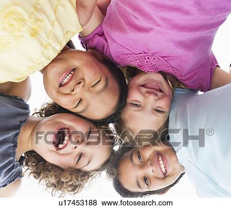 Stock Photo - Portrait of girls (6-9) in huddle. Fotosearch