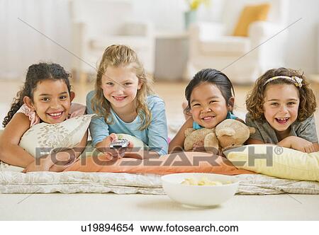 Portrait of girls (6-9) watching TV View Large Photo Image Picture - Portrait of girls (6-9) watching TV. Fotosearch