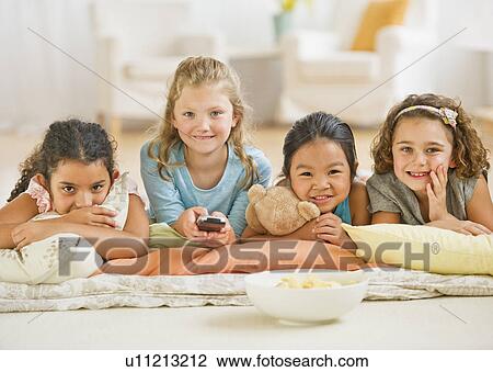 Portrait of girls (6-9) watching TV View Large Photo Image Stock Image - Portrait of girls (6-9) watching TV. Fotosearch