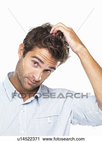 Stock Image - Portrait of handsome young executive scratching head. Fotosearch