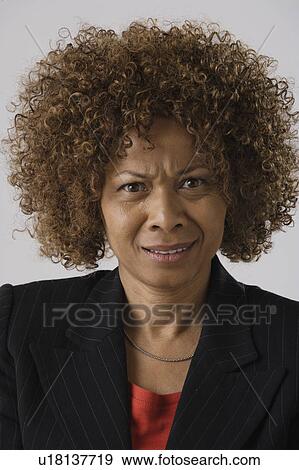 Stock Photo - Portrait of mature businesswoman, studio shot. Fotosearch