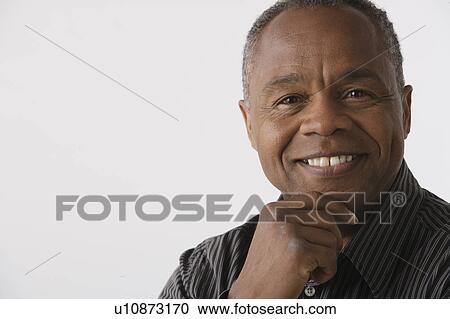 Stock Image - Portrait of mature man, studio shot. Fotosearch