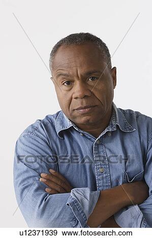 Stock Photo - Portrait of mature man, studio shot. Fotosearch