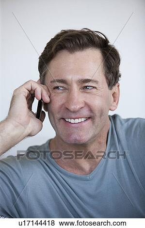 Stock Photo - Portrait of mature man with mobile phone. Fotosearch