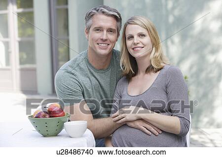 Stock Image - Portrait of pregnant woman and husband. Fotosearch
