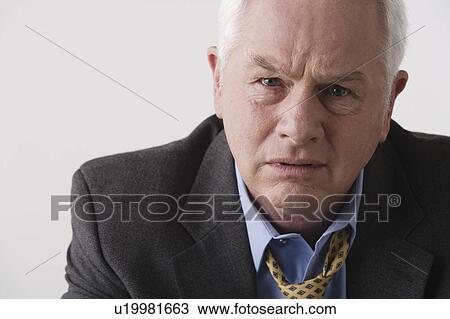 Stock Image - Portrait of senior businessman, studio shot. Fotosearch