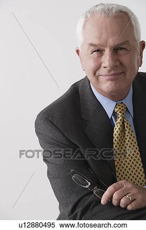 Portrait of senior businessman, studio shot View Large Photo Image Stock Photography - Portrait of senior businessman, studio shot. Fotosearch