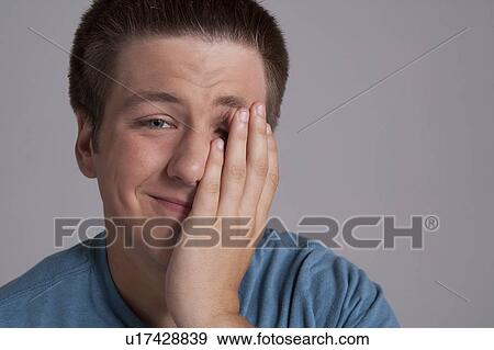 Stock Photo - Portrait of sleepy teenager, studio shot. Fotosearch