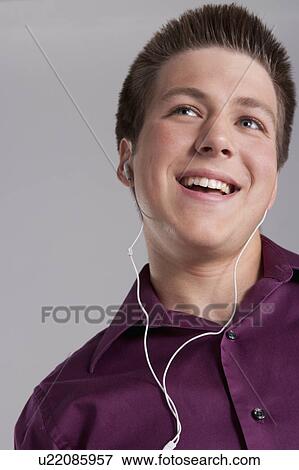 Portrait of smiling teenager with earphones, studio shot View Large Photo Image Stock Photo - Portrait of smiling teenager with earphones, studio shot. Fotosearch