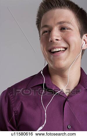 Portrait of smiling teenager with earphones, studio shot View Large Photo Image Stock Photograph - Portrait of smiling teenager with earphones, studio shot. Fotosearch