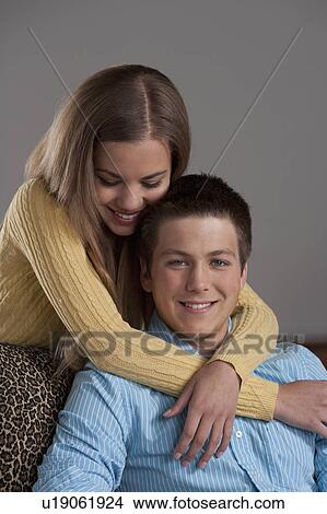 Portrait of teenage couple (16-17), studio shot View Large Photo Image Picture - Portrait of teenage couple (16-17), studio shot. Fotosearch