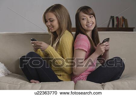 Portrait of teenage girl (16-17) with young woman sitting on sofa View Large Photo Image Stock Image - Portrait of teenage girl (16-17) with young woman sitting on sofa. Fotosearch